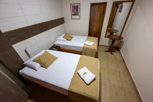 Ένα ή περισσότερα κρεβάτια σε δωμάτιο στο Hostal Macambo