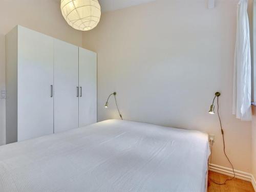 a bedroom with a white bed and two lamps at Holiday Home Belenda by Interhome in Silkeborg