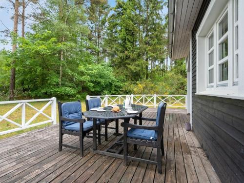 a table and chairs on a wooden deck at Holiday Home Belenda by Interhome in Silkeborg