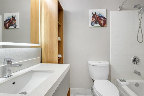 a bathroom with a white toilet and a sink at Best Western Richmond Hotel in Richmond