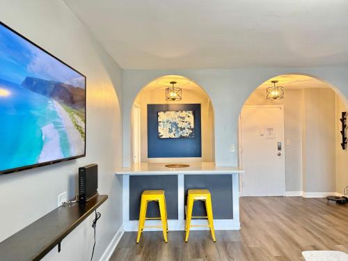 a room with two yellow stools in front of a desk at Downtown! 5 Beds! Onsite Parking! City View! New Renovated! LM1806 in Atlanta