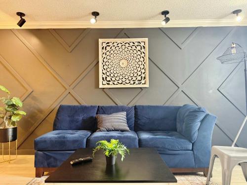 a blue couch in a living room with a table at Downtown! Free Onsite Parking! City View! LM1706 in Atlanta