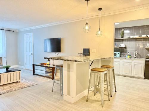 a kitchen with a large island with bar stools at Downtown! Free Onsite Parking! City View! LM1706 in Atlanta