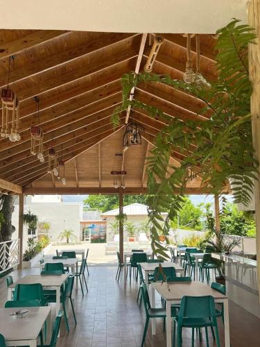 a restaurant with tables and chairs and a patio at Samaná Suites Hotel by Habita in Santa Bárbara de Samaná