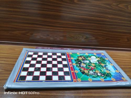 a chess board sitting on top of a table at Street 7 Apartment in Bahawalpur