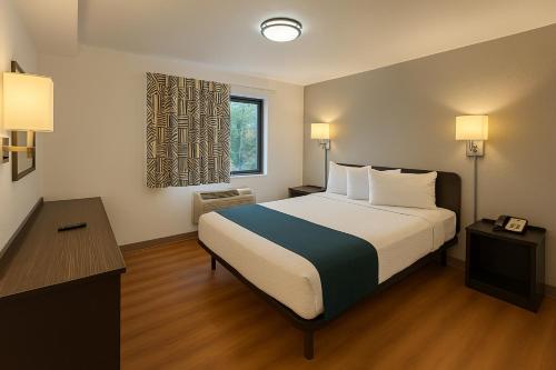 a hotel room with a bed and a window at Motel 6-Duluth, MN in Duluth