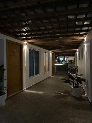 a hallway of a building with a door and a plant at Samaná Suites Hotel by Habita in Santa Bárbara de Samaná