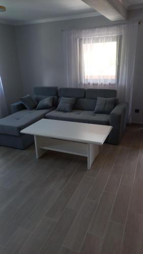 a living room with a couch and a coffee table at Casa Edy in Vişeu de Sus