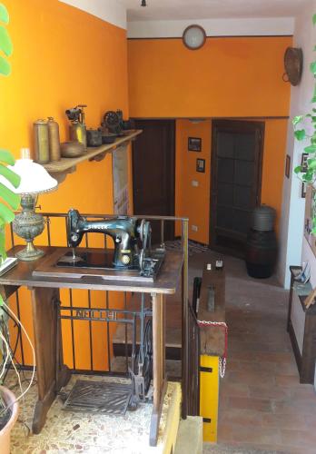 a kitchen with a sewing machine on a wooden table at l'Oca Mannara in Ameno