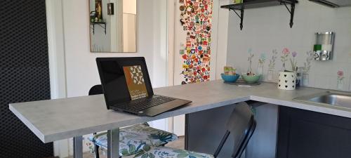 a laptop computer sitting on a counter in a kitchen at Il Giardino Home in Lippo di Calderara di Reno