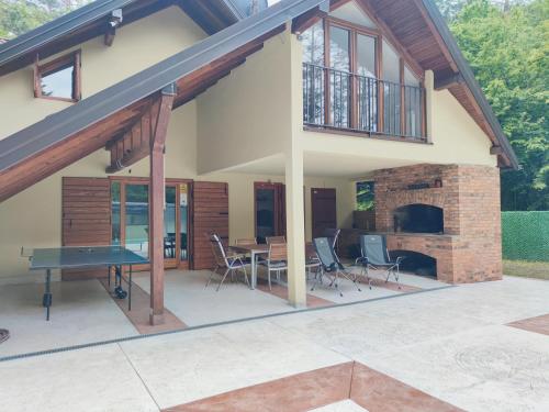a house with a patio with a ping pong table at Villa Kamenica in Zavidovići