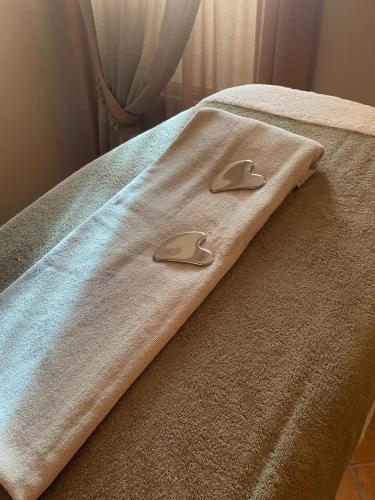 a blanket on a bed with two handles on it at Corte Uccellanda Relais & Spa in Monzambano