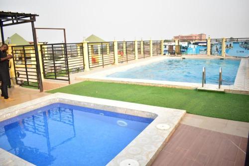 a large swimming pool on top of a building at MiniGolf, MeteoMode & B2B RESIDENCE Ekoumdoum - DAHARA APPARTS in Yaoundé