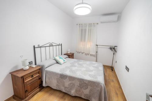 a bedroom with a bed and a wooden floor at Villa Ortega Alba in Alcalá la Real