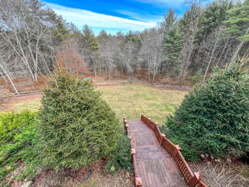 a wooden bridge with two christmas trees in a field at An Appalachian Hideaway in Brownwood