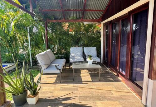 two chairs and a table on a patio at La Cabaña de Merce in Tanque