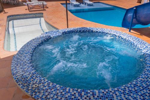 a large swimming pool with a blue tiled floor at Lago Calima - Bella Finca in Madroñal