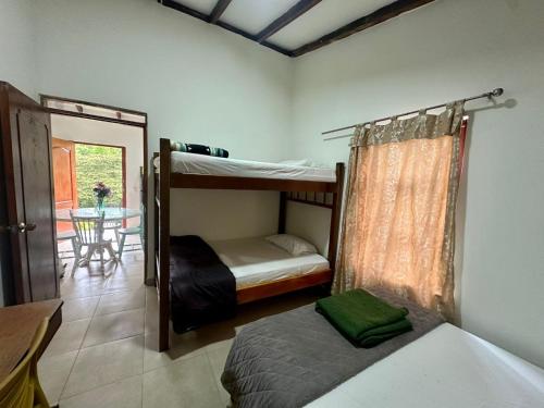 a bedroom with two bunk beds and a table at Lago Calima - Bella Finca in Madroñal