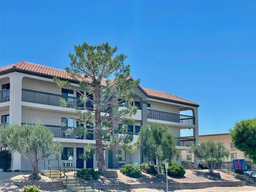 an apartment building with a tree in front of it at Motel 6 Barstow, CA I15 and Lenwood Road in Barstow