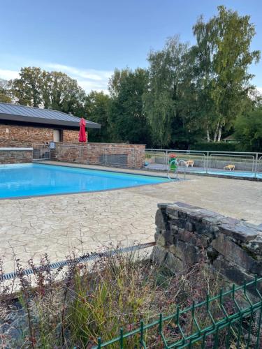 a swimming pool with a person standing next to it at La Luna in Lanaken
