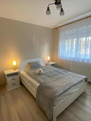 a bedroom with a bed with a stuffed animal on it at The Cozy Nest in Carei