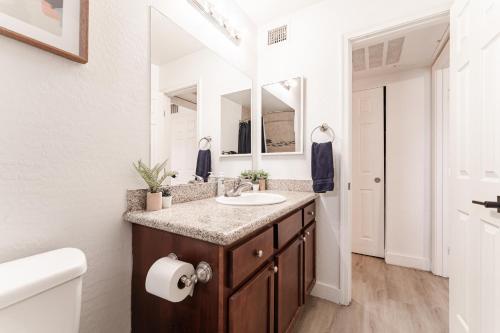 a bathroom with a sink and a mirror at Central PHX Deluxe 1 BR King Bed & Patio w Pool in Phoenix