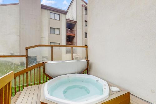 a bath tub sitting on top of a balcony at Summit House East in Copper Mountain