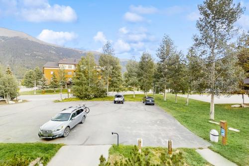 a parking lot with cars parked in front of a building at Summit House East in Copper Mountain