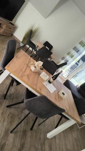 a wooden table with chairs around it in a room at Haus Kleeblatt in Cochem