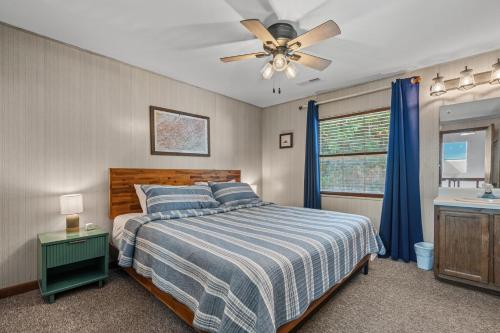 a bedroom with a bed and a ceiling fan at A Tram View Scenic Mountain Views and see the Gatlinburg historic cable tram pass by in Gatlinburg