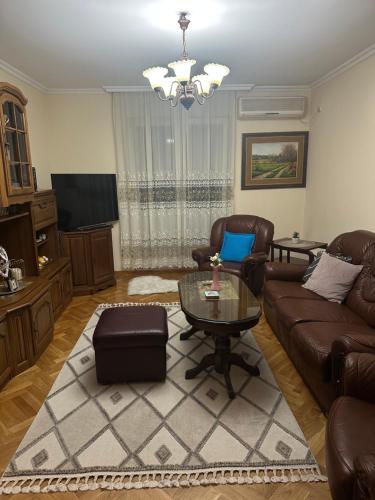 a living room with a couch and a table at Central apartment Zemun in Zemun