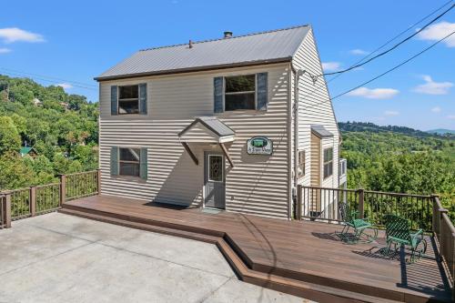 a house with a wooden deck with a balcony at A Tram View Scenic Mountain Views and see the Gatlinburg historic cable tram pass by in Gatlinburg