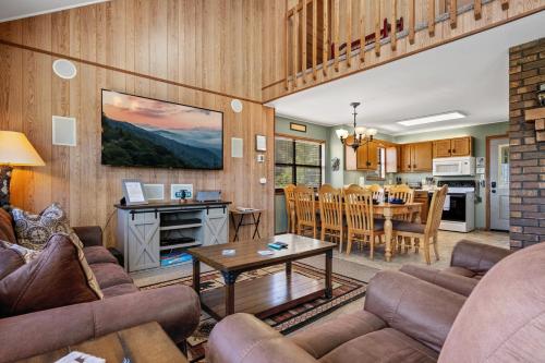 a living room with a couch and a table at A Tram View Scenic Mountain Views and see the Gatlinburg historic cable tram pass by in Gatlinburg