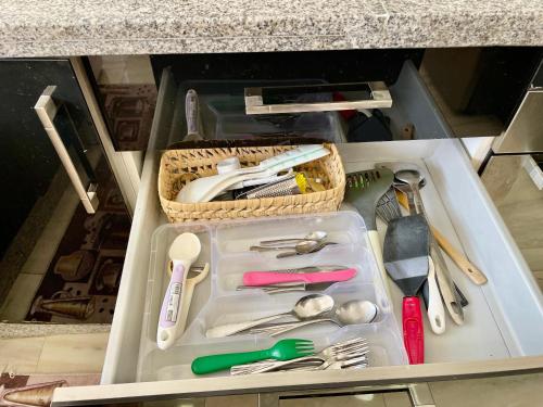 a drawer with a basket of utensils in it at Prestigia luxury appartement in Fès
