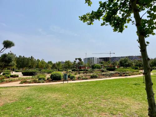 a park with green grass and a tree at Prestigia luxury appartement in Fès