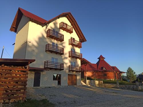 a building with wooden balconies on the side of it at У Павла in Yablunytsya