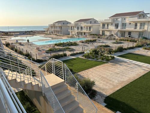 an aerial view of a resort with a swimming pool at Flamingo Apartment in Pachino