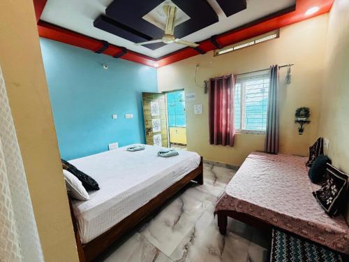 a bedroom with a bed and a ceiling at SAHASRA HOME STAY HAMPi in Hospet