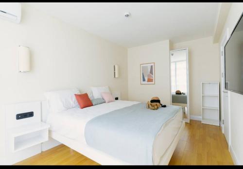 a white bedroom with a large white bed at ORBI CITY LUXURY deluxe KIG DVD in Batumi