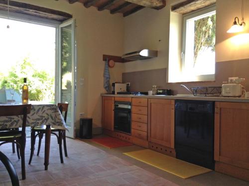 a kitchen with a table and a dining room at La Doccia in Anghiari