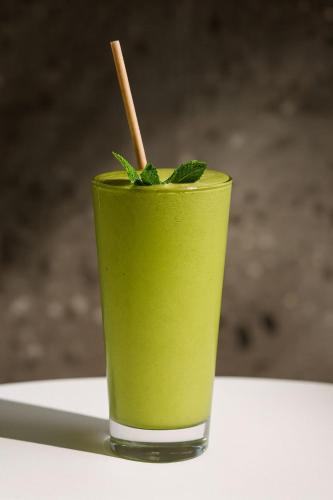 a green drink is sitting on a table at Nassau Suite South Beach, an All Suite Hotel in Miami Beach