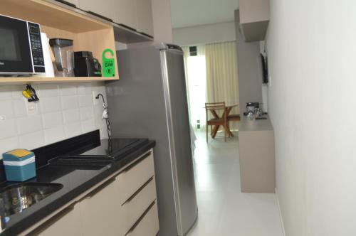 a kitchen with a stainless steel refrigerator in a room at ArtStudio Open Spaces in Salvador