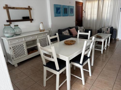 a white table and chairs in a living room at Apartamentos Burgao in Caleta de Sebo