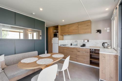 a kitchen and dining room with a table and chairs at Maison de Vacances - Parc de Vacances Papillon Bouillon in Bouillon