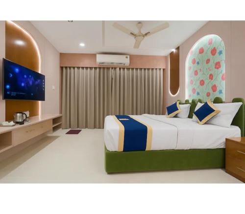 a bedroom with a large bed and a television at HoTEL HILL PARK in Indore
