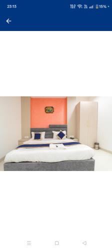 a bedroom with a bed with an orange headboard at HoTEL HILL PARK in Indore