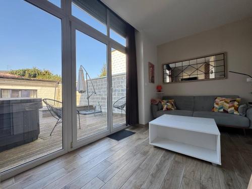 a living room with a couch and a table at Cozy Home - Appartement Arras in Arras