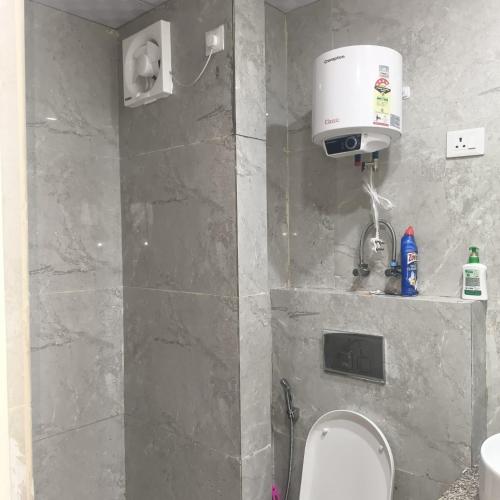 a bathroom with a sink and a toilet in it at Anmolairbnb in Greater Noida