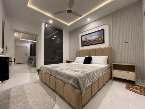 a bedroom with a large bed in a room at The Greystone Luxe in Rawalpindi