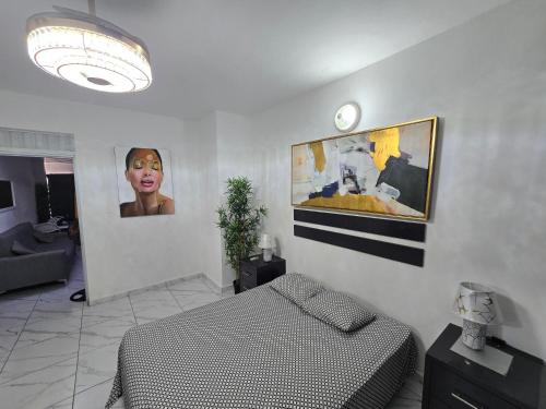 a bedroom with a bed and a picture on the wall at Linkzup Europa Condos in Sosúa